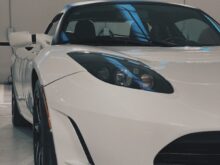 a white sports car parked in a garage