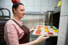 Žena vkládá pečivo do trouby