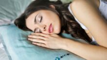 woman sleeping on blue throw pillow