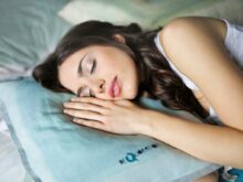 woman sleeping on blue throw pillow