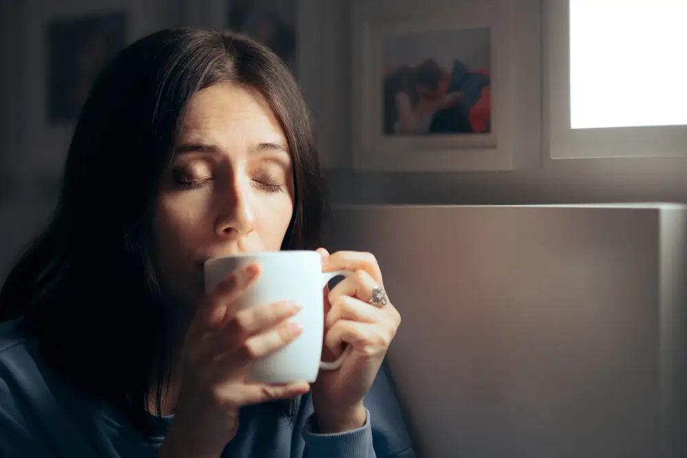 Žena pije z hrnku