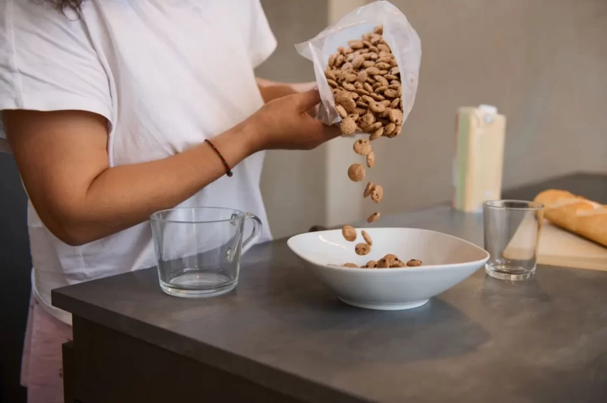 Žena sype do misky cereálie