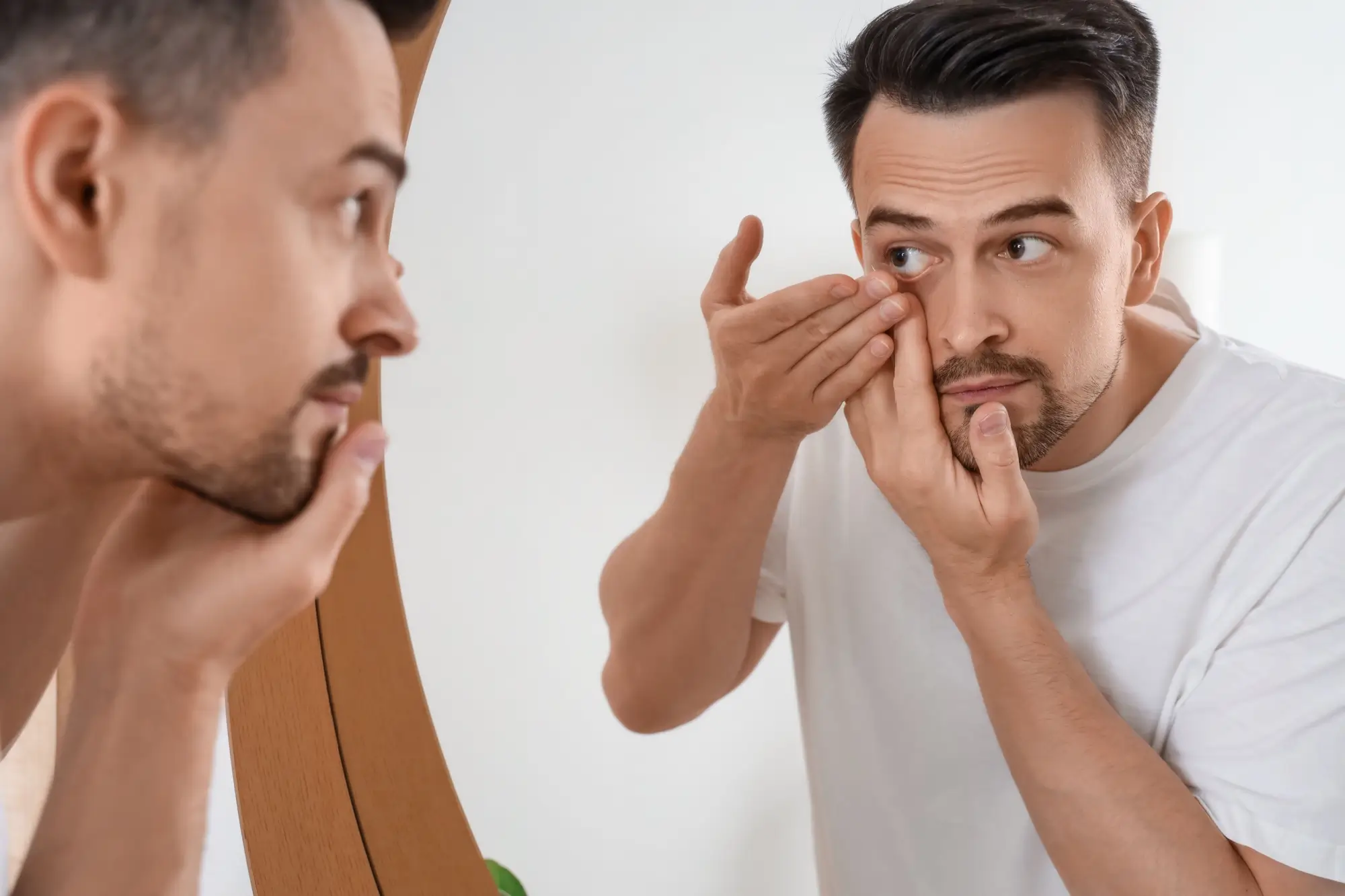 Shutterstock_2495991107 - Techsvět Muž si nasazuje kontaktní čočky