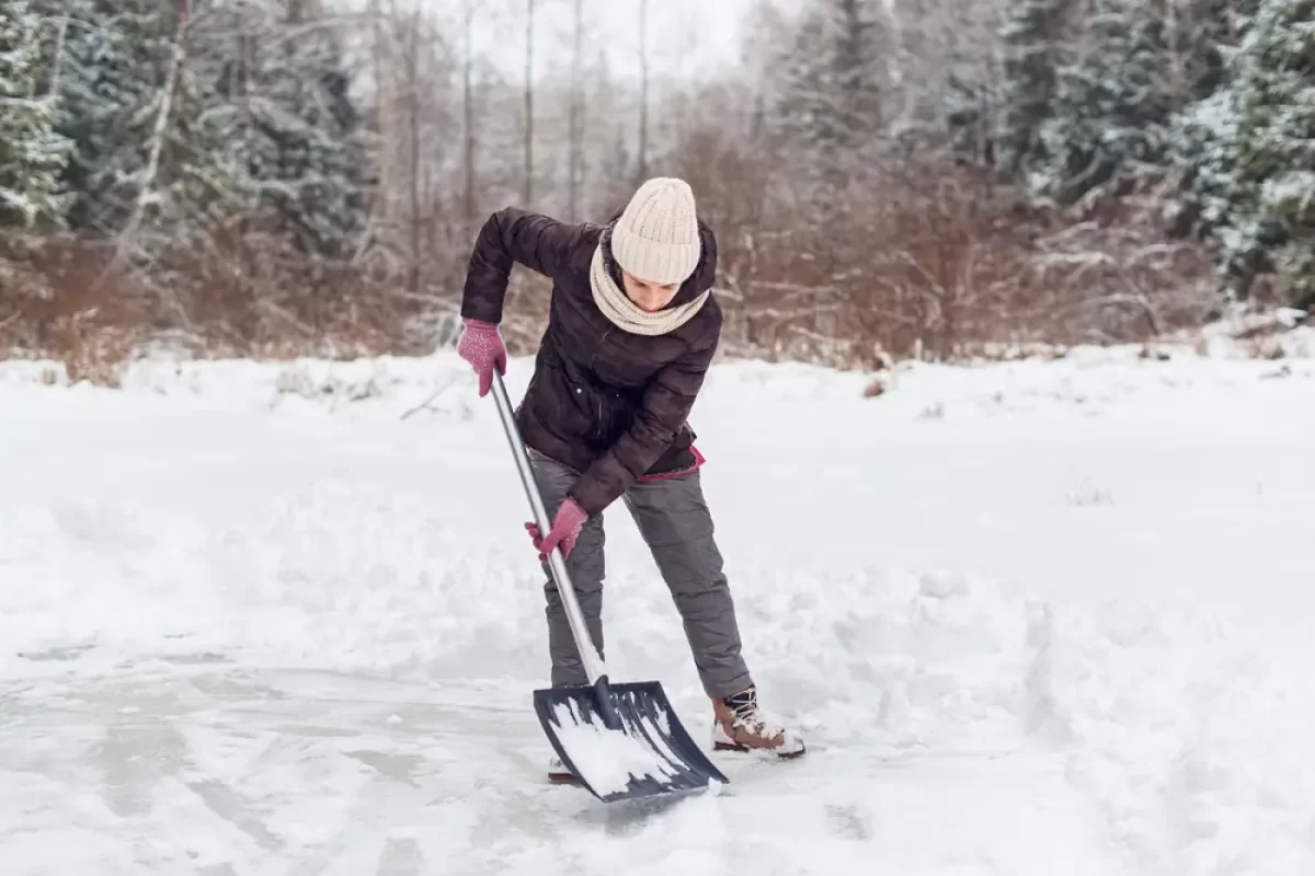Žena odklízející sníh