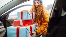 žena dává vánoční dárky do auta