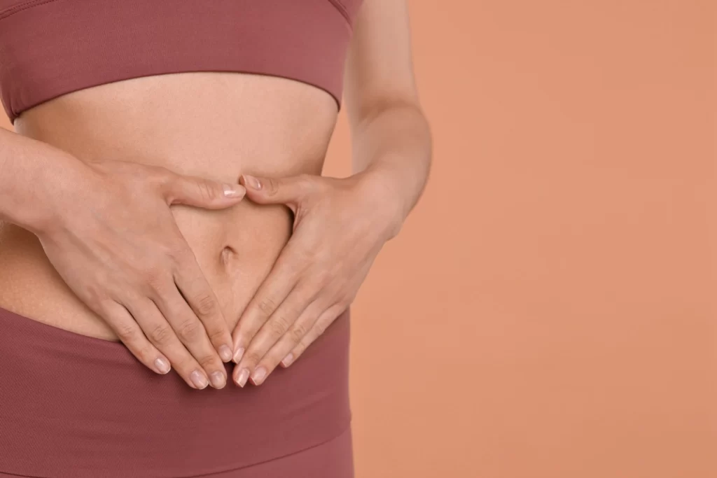 Probiotické nápoje napomáhají lepšímu trávení. Zdroj: Shutterstock - Techsvět žena si sahá na břicho