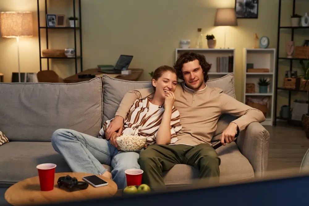 Žena a muž sledují televizi
