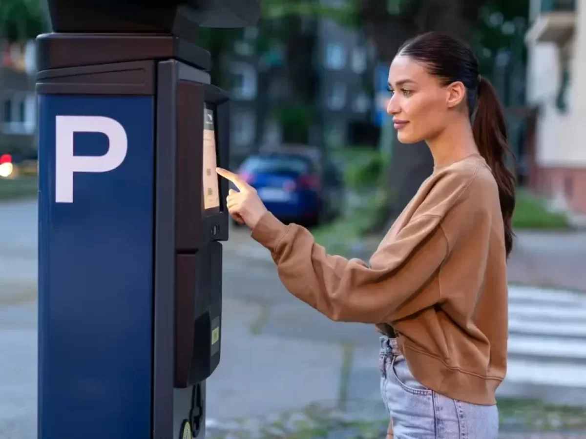 Žena zadává údaje do parkovacího automatu