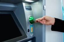 Žena vkládá kartu do bankomatu