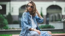 žena sedící v džínech a džínové bundě