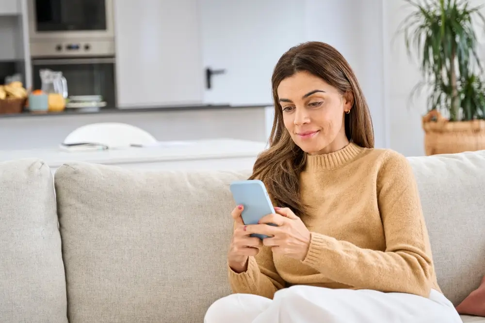 Žena se dívá do mobilu