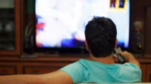 Muž sleduje televizi