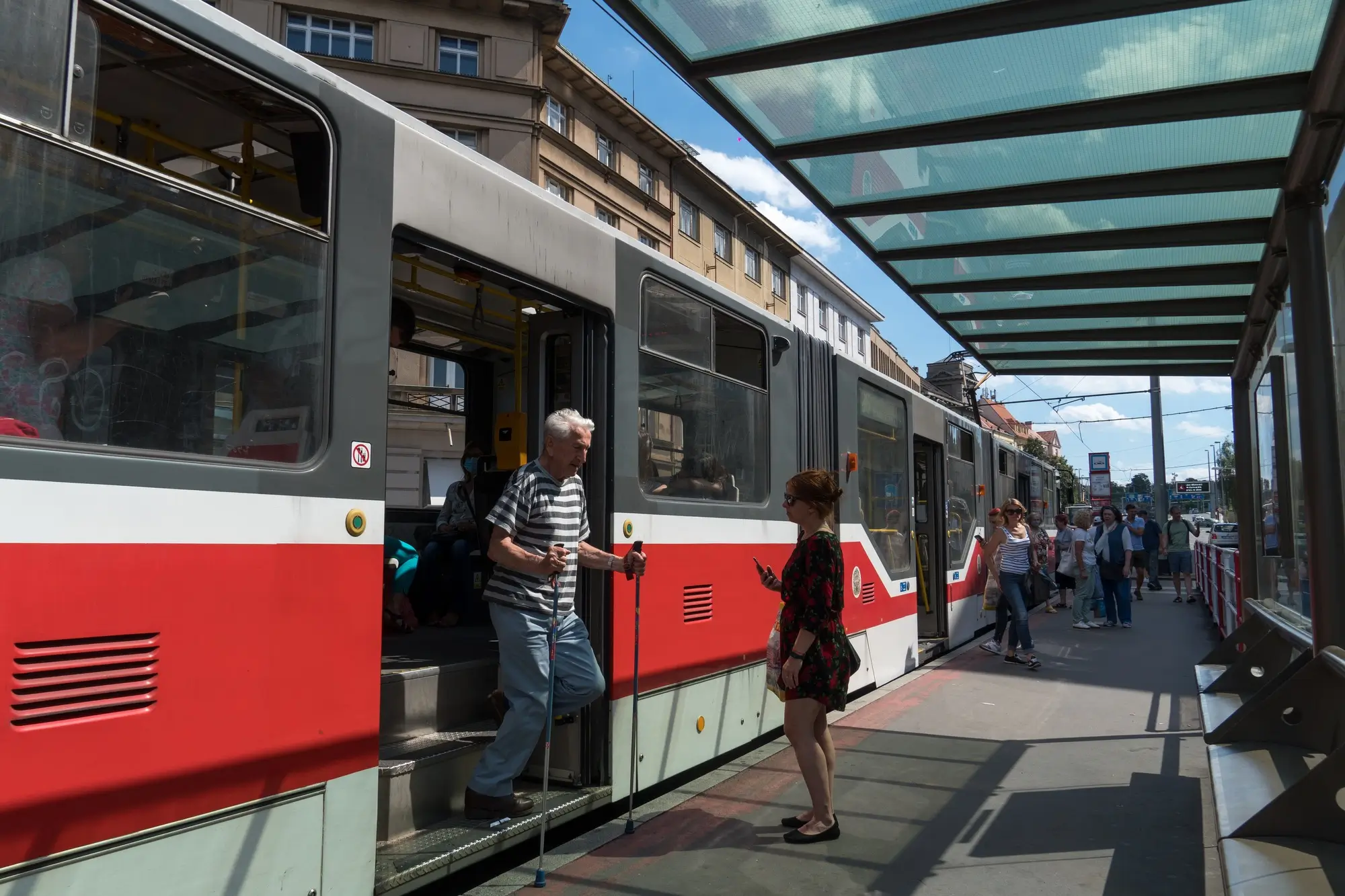 Důchodce vystupuje z tramvaje