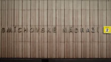 Část fasády budovy Smíchovského nádraží v Praze. Dominantním prvkem je nápis „SMÍCHOVSKÉ NÁDRAŽÍ“ umístěný na svisle členěné betonové nebo kamenné stěně ve stylu typickém pro poválečný funkcionalismus.