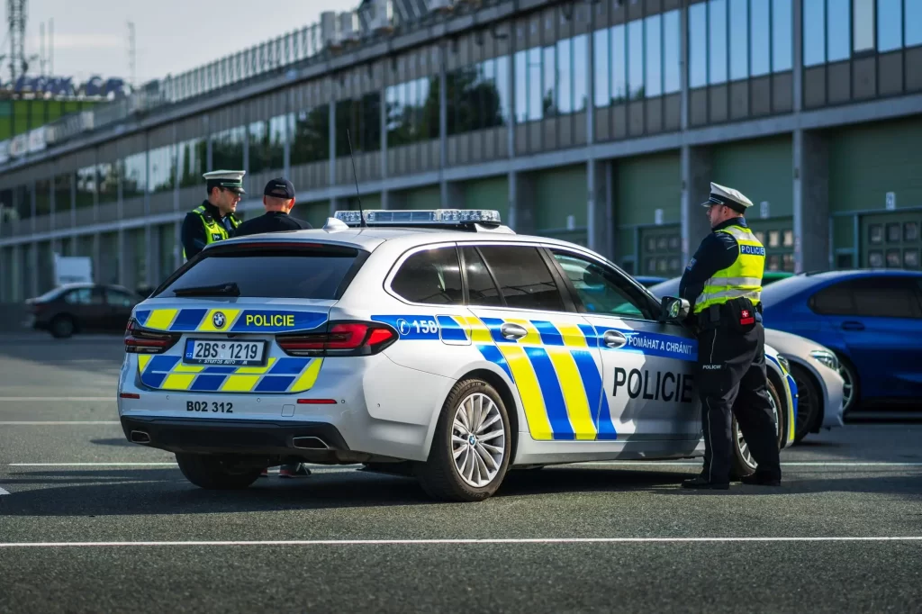 policisté u policejního auta