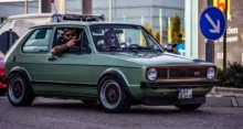 Volkswagen Golf GTI Mk1 ve skvělém stavu. Auto má typickou karoserii první generace s červeným rámečkem v masce chladiče, černými plastovými nárazníky a sportovními koly BBS.