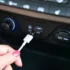 Ruka dává kabel do USB v autě