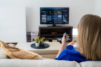 Žena sedí u televize