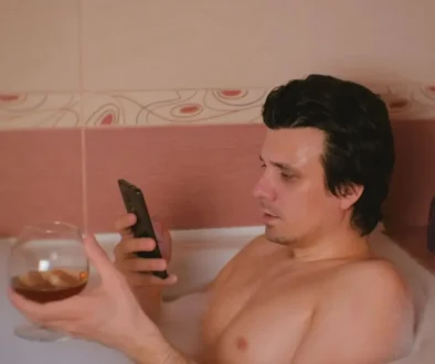 muž s telefonem ve vaně