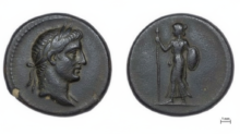 Ancient coin with a left-facing male head (obverse) and a standing female figure with spear and shield (reverse); scale shows 1 mm.