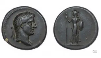 Ancient coin with a left-facing male head (obverse) and a standing female figure with spear and shield (reverse); scale shows 1 mm.