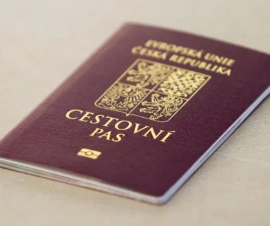 Czech passport with gold crest on a maroon cover resting on a light surface, close-up view