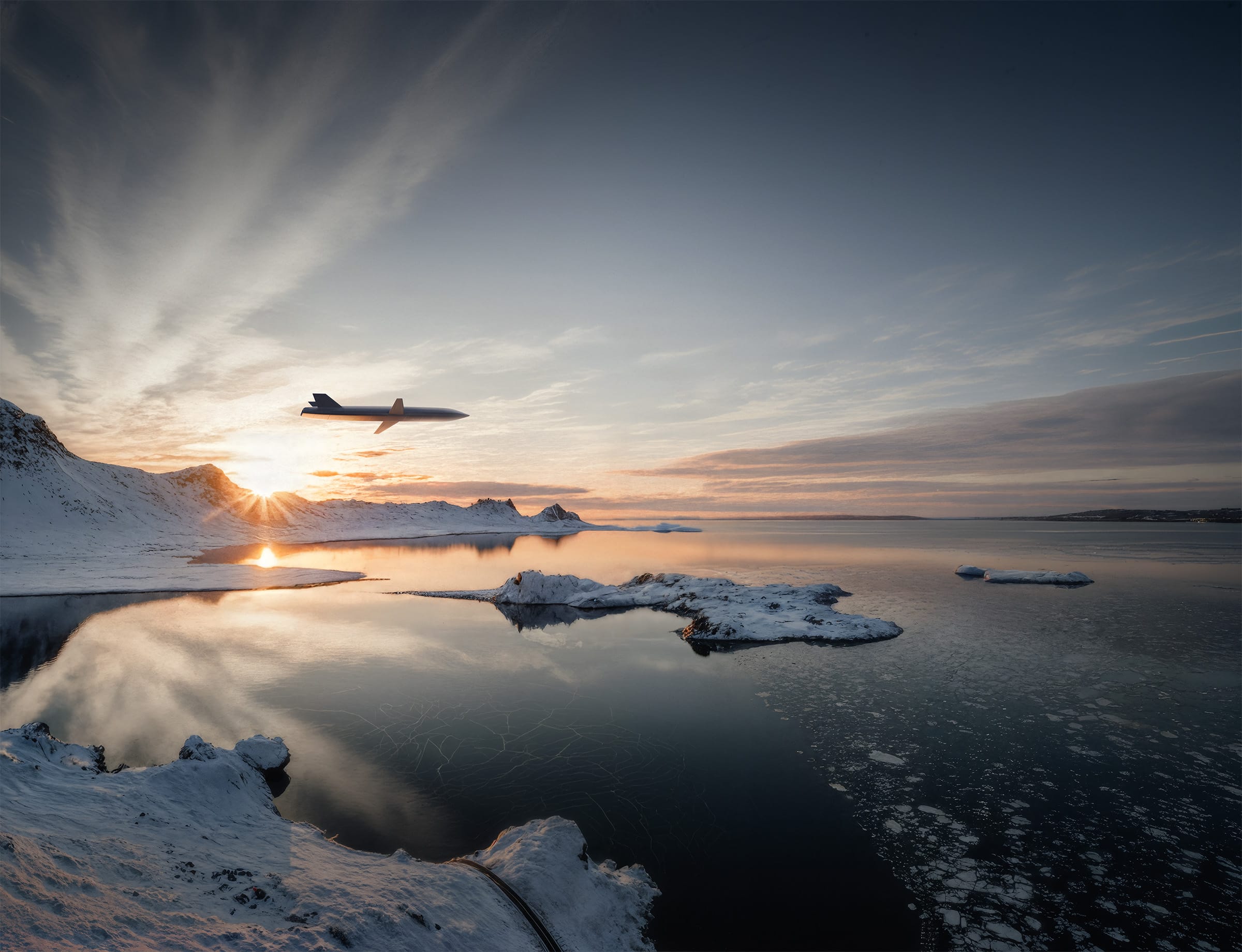Jet plane flying low over a snowy coastline at sunset with icy mountains in the background and a calm reflective inlet below.